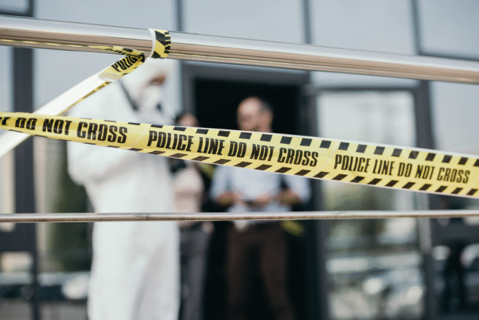 close-up-view-of-police-line-with-blured-detective-2024-11-19-15-16-44-utc