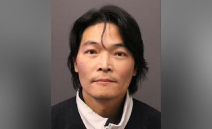 Luigi_KONG Police-released photo of a middle-aged man with short dark hair and a neutral expression, wearing a dark jacket and light collared shirt.