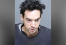 Toronto man charged in sexual assault investigation near Kipling and Lake Shore A head-and-shoulders police-released photograph of a man with short, dark, spiked hair, wearing a dark sweatshirt, photographed against a plain blue background.