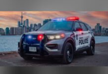 Toronto man charged in suspected hate-motivated criminal harassment case A Toronto Police Service cruiser with emergency lights flashing is parked along the waterfront at dusk, with the Toronto skyline and CN Tower visible in the background