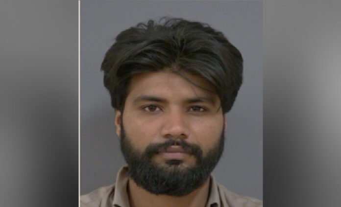 Police released headshot of a man with straight black hair and balck full beared against a plain background