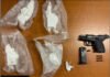 Two arrested in Toronto and Mississauga firearm investigation A photo of evidence laid out on a wooden table, including a black semi-automatic handgun, a detached magazine, several loose bullets, and multiple clear plastic bags containing a white powdery substance.
