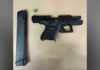 Two Toronto residents charged after loaded handgun seized in Scarborough A black handgun on a light surface with a separate extended magazine placed beside it.