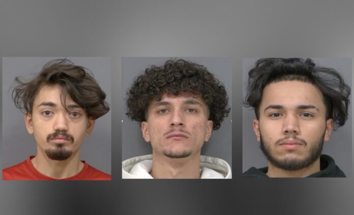 Four arrested after alleged trafficking of girls across GTA, police say Three side-by-side headshots of young men against plain backgrounds. Each is facing the camera with a neutral expression. The man on the left has medium-length hair and light facial hair, wearing a red top. The man in the centre has short curly hair and a hoodie. The man on the right has dark hair and light facial hair, wearing a dark top.