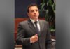 Former Toronto city councillor, Ontario MPP Giorgio Mammoliti dead at 64 Former MPP Giorgio Mammoliti in a dark suit, white shirt, and patterned tie speaks while gesturing with one hand, appearing to address a meeting or hearing. He is indoors, with a microphone and blurred plants visible in the background, suggesting a formal or institutional setting.