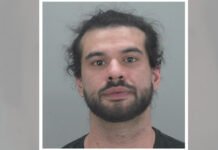 Hamilton registered massage therapist charged with sexual assault; police seek additional potential victims Police released head-and-shoulders photo of a man with dark hair and a full beard, looking straight at the camera against a plain light background.