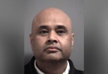$30,000 retail theft: Brampton man charged with stealing alcohol, butter, and ghee headshot photo of a middle-aged man facing the camera. He has a shaved head, a slight moustache and stubble, and is wearing a dark jacket.