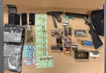Toronto man arrested after loaded guns, drugs seized in Northwest End search Items seized during a Toronto police firearm investigation displayed on a table, including two handguns, a sawed-off shotgun, multiple magazines, boxes and loose rounds of ammunition, several smartphones, Canadian currency, marijuana in a jar and plastic bags, and other related items.