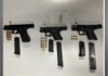 Toronto Police arrest three in major firearms investigation Three handguns displayed alongside multiple magazines and groups of ammunition, arranged on a white surface.