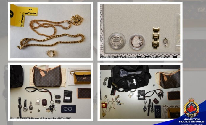 seizure by police A four-panel police evidence display showing items believed to be recovered property. The top-left image shows two gold-coloured chain necklaces and a ring placed on a white surface beside a yellow evidence marker. The top-right image shows several watches and circular jewellery pieces arranged next to a measurement scale. The bottom-left image displays designer-style handbags, wallets, sunglasses, keys, and multiple wristwatches laid out in rows. The bottom-right image shows additional bags, jewellery, watches, and personal accessories arranged for documentation.