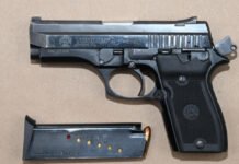 Teen charged in two ride-share carjackings in Brampton A silver Taurus semi-automatic handgun with a black grip is shown beside a detached magazine containing several rounds of ammunition, displayed as seized evidence.