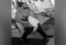 Police release image of suspect wanted in East-End stabbing investigation survellence image of a male wearing a black winter jacket, black jeans, black sneakers, a grey scarf, glasses, and carrying a black satchel.