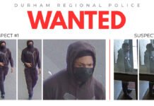 $15,000 reward offered for arrest of suspects in Oshawa murder A Durham Regional Police “WANTED” poster displaying surveillance images of two suspects. Suspect #1 is shown walking while wearing a dark hoodie with a Puma logo, dark pants, and a black face covering. Suspect #2 appears in separate images wearing a dark hooded jacket and standing inside a building entrance area.